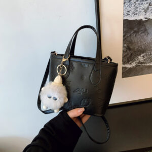 Textured handbag with pendant